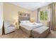 Bright bedroom with queen bed, chair, bench, and natural light from the large window at 3149 Brasilia Ave, Kissimmee, FL 34747