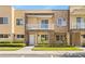 Beautiful two-story townhome features a private balcony, stone accents, and manicured landscaping at 3149 Brasilia Ave, Kissimmee, FL 34747