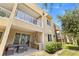 Multi-level home exterior with outdoor patio, dining, built-in grill, and blue skies at 3149 Brasilia Ave, Kissimmee, FL 34747