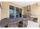 Outdoor patio with dining table, built-in grill, sink, and granite countertops at 3149 Brasilia Ave, Kissimmee, FL 34747