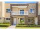 Charming two-story townhome features a private balcony, stone accents, and welcoming curb appeal at 3149 Brasilia Ave, Kissimmee, FL 34747