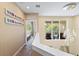 Bright hallway with modern chandelier, artwork, and view to the balcony featuring a comfortable lounge area at 3149 Brasilia Ave, Kissimmee, FL 34747