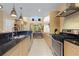 Modern kitchen with a granite countertop, stainless steel appliances, and contemporary cabinetry at 3149 Brasilia Ave, Kissimmee, FL 34747