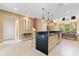 Open-concept kitchen with a large island, stainless steel appliances, and access to an outdoor view at 3149 Brasilia Ave, Kissimmee, FL 34747