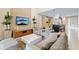 Comfortable living room with cozy seating, open floor plan, and view of the kitchen island and dining area at 3149 Brasilia Ave, Kissimmee, FL 34747