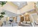 Bright and open living room featuring tall window, comfortable seating, and view of the open floor plan at 3149 Brasilia Ave, Kissimmee, FL 34747