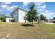Exterior view of the home featuring a well-maintained lawn and mature trees at 31792 Broadwater Ave, Leesburg, FL 34748