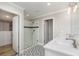Bathroom featuring a glass-enclosed shower, double vanity, and adjacent walk-in closet at 31792 Broadwater Ave, Leesburg, FL 34748