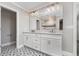 Bathroom with a dual sink vanity, modern fixtures, and a decorative tile floor at 31792 Broadwater Ave, Leesburg, FL 34748