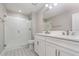 Bathroom featuring double sinks, quartz counters, and a walk-in shower with white subway tile at 31792 Broadwater Ave, Leesburg, FL 34748
