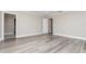 Spacious bedroom offers plank floors, neutral walls, and a view of the en suite at 31792 Broadwater Ave, Leesburg, FL 34748