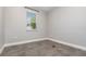 Clean and bright bedroom with large window and tile floors at 31792 Broadwater Ave, Leesburg, FL 34748