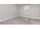 Neutral bedroom featuring a window and neutral carpet at 31792 Broadwater Ave, Leesburg, FL 34748
