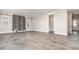 Open-concept living area with modern tile flooring, neutral paint and doorway to a half bathroom at 31792 Broadwater Ave, Leesburg, FL 34748