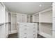 Large walk-in closet featuring custom shelving and built-in drawers for optimal storage at 31792 Broadwater Ave, Leesburg, FL 34748