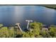 Expansive lake view featuring long wooden docks and boat slips, surrounded by lush greenery and tranquil water at 3349 Sagebrush St, Harmony, FL 34773