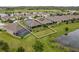 An aerial rear view of the property that borders a pond and shows the lot lines at 3349 Sagebrush St, Harmony, FL 34773