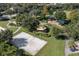 An aerial view shows a volleyball court, playground, picnic pavilion and walking trails surrounded by mature trees at 3349 Sagebrush St, Harmony, FL 34773