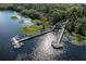 Panoramic lake view showcases boat docks and slips, fringed by verdant trees and shimmering water reflections at 3349 Sagebrush St, Harmony, FL 34773