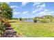 Scenic backyard view with a lake, lush greenery, and clear blue skies at 3349 Sagebrush St, Harmony, FL 34773