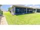Wide shot of backyard and screened in patio with lush green grass at 3349 Sagebrush St, Harmony, FL 34773