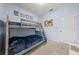This bedroom features a comfortable bunk bed, blue walls and accent paintings on the walls at 3349 Sagebrush St, Harmony, FL 34773