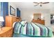 Charming bedroom features a plush bed, wooden dresser, and neutral walls with a ceiling fan and bright windows at 3349 Sagebrush St, Harmony, FL 34773