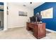 Bedroom with a solid wood desk with computer, blue accent wall, and a ceiling fan at 3349 Sagebrush St, Harmony, FL 34773