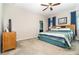 Comfortable bedroom with neutral carpet, ceiling fan, and bright windows with natural light and wooden furniture at 3349 Sagebrush St, Harmony, FL 34773