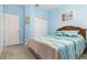 Inviting bedroom with soft carpet, light blue walls, and slider door closet at 3349 Sagebrush St, Harmony, FL 34773