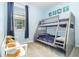 Cozy room with bunkbeds, a window with blinds, and light blue walls at 3349 Sagebrush St, Harmony, FL 34773