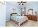 Comfortable bedroom featuring a ceiling fan, soft carpet, and wood dresser at 3349 Sagebrush St, Harmony, FL 34773