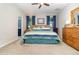 Inviting bedroom with a cozy carpet, a ceiling fan, and large dresser with generous natural light at 3349 Sagebrush St, Harmony, FL 34773
