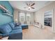 Bonus room/den area with a blue couch and a door leading to a room with bunkbeds at 3349 Sagebrush St, Harmony, FL 34773