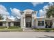 The attractive community center entrance is flanked by white columns, mature landscaping and ample parking at 3349 Sagebrush St, Harmony, FL 34773