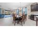 Spacious dining area with an adjacent living room and a large wooden table with seating for eight at 3349 Sagebrush St, Harmony, FL 34773