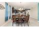 Dining table looking to kitchen featuring dark cabinetry, stainless appliances, and breakfast bar at 3349 Sagebrush St, Harmony, FL 34773