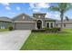 Charming single-story home with a well-manicured lawn and lush landscaping at 3349 Sagebrush St, Harmony, FL 34773