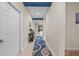 Inviting hallway featuring blue accent beams and a stylish runner rug at 3349 Sagebrush St, Harmony, FL 34773