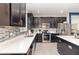 Modern kitchen featuring granite counters, stainless steel appliances, and dark cabinets with a tile backsplash at 3349 Sagebrush St, Harmony, FL 34773