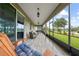 This gorgeous lanai offers an outdoor seating area with views of the lush green landscaping at 3349 Sagebrush St, Harmony, FL 34773