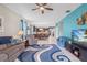 Bright living room flows into the kitchen and features stylish furnishings and a vivid accent wall at 3349 Sagebrush St, Harmony, FL 34773