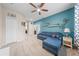 Bright and airy living room with modern decor, blue sectional, and ample natural light at 3349 Sagebrush St, Harmony, FL 34773