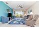 Bright living room featuring comfortable seating, a large TV, and a sliding glass door leading to the patio at 3349 Sagebrush St, Harmony, FL 34773