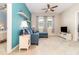 Comfortable living room features a blue accent wall, plush sofa, and large windows, creating a welcoming space at 3349 Sagebrush St, Harmony, FL 34773