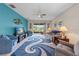 Comfortable living room with a blue accent wall, large TV, and sliding glass doors to the patio at 3349 Sagebrush St, Harmony, FL 34773