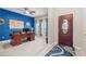 Home office with a large wooden desk, blue accent wall, and patterned curtains at 3349 Sagebrush St, Harmony, FL 34773