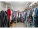 Walk-in closet with custom shelving and hanging rods for organized storage at 3349 Sagebrush St, Harmony, FL 34773