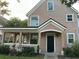 Charming two-story home featuring a covered front porch and manicured landscaping, enhancing its curb appeal at 3417 Westchester Square Blvd # 202, Orlando, FL 32835