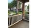 Covered front porch with white railing and view of landscaped walkway and neighborhood at 3417 Westchester Square Blvd # 202, Orlando, FL 32835